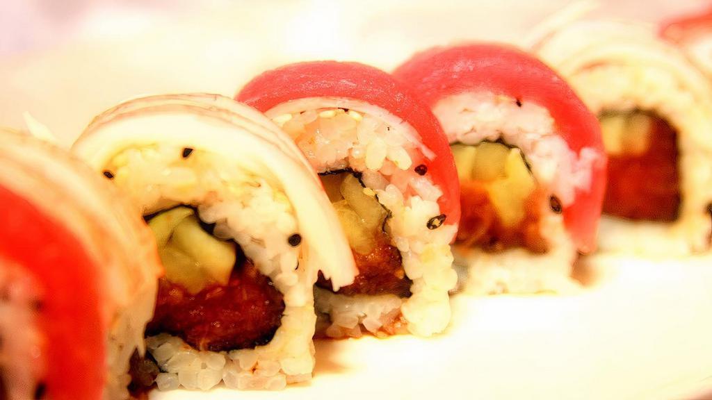 Sooner · Spicy tuna and cucumber roll topped with ahi tuna and crab sticks drizzled with spicy sweet sauce.