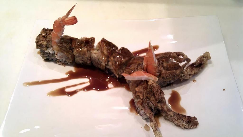 Scorpion · Crab mix, avocado, and tempura crispy roll topped with a fried “jumbo” soft shell crab with shrimp and sweet sauce to garnish.