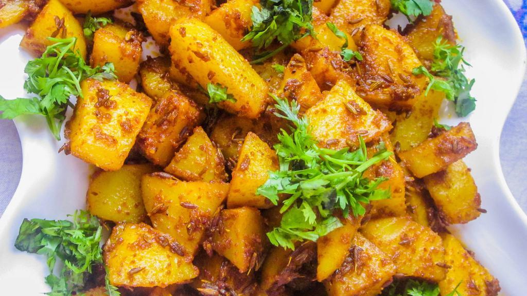 Jeera Aloo - Vegan · Potatoes cooked with Cumin & tempering spices.