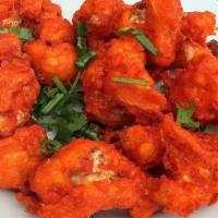 Gobi Manchurian · House special golden chicken in mildly spiced soya garlic sauce cooked with fresh cilantro, ...