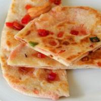 Kashmiri Naan · Flat Bread Stuffed With Variety Of Grounded Dry Nuts & Raisins.