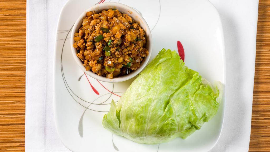 Lettuce Wraps · Minced chicken, water chestnuts and green onions stir-fried in a light brown sauce.