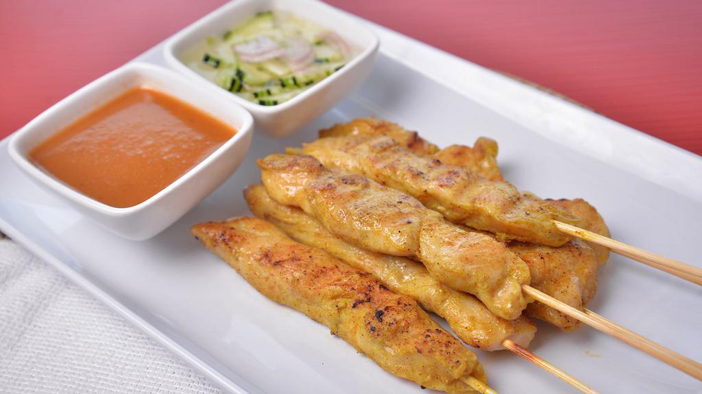 Satay (5 Pieces) · Gluten-free. Marinated chicken on a skewer, served with cucumber sauce and peanut sauce.