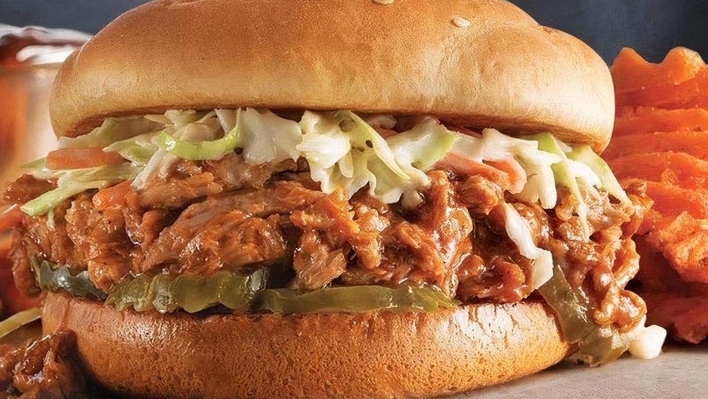 Sweet 'N Smoky Pulled Pork Sandwich · Pulled pork marinated with our sweet 'n smoky BBQ sauce on a bed of pickles, topped with creamy coleslaw for a can't miss summer sandwich.