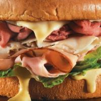 Butcher Block Sandwich · The legend returns…slow roasted beef, smoked turkey and hickory ham piled high on a brioche ...