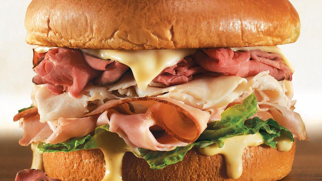 Butcher Block Meal · The legend returns…slow roasted beef, smoked turkey and hickory ham piled high on a brioche bun. Topped with Swiss cheese, a blend of honey horseradish sauce and romaine lettuce. Served with regular natural-cut fries and a regular drink.