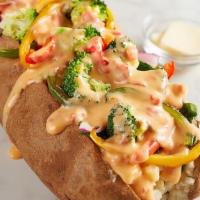 Veggie Spud · Spinach, broccoli, red onions, house-roasted multicolored peppers, and RO*TEL cheese sauce.