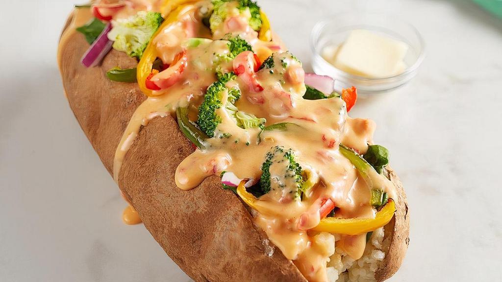 Veggie Spud · Spinach, broccoli, red onions, house-roasted multicolored peppers, and RO*TEL cheese sauce.