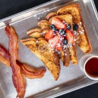 Traditional French Toast · Topped with Fresh Strawberries and Blueberries served with log cabin maple syrup, powdered s...