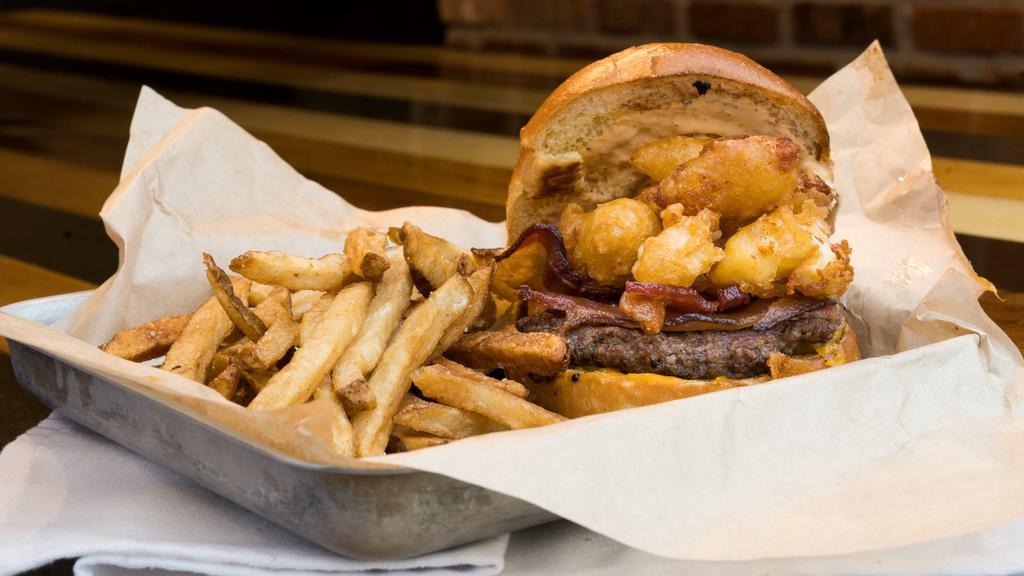 Cheese Curd Burger · Grilled Angus steak burger topped with battered white cheddar cheese curds, thick-cut bacon and topped with chipotle ranch.