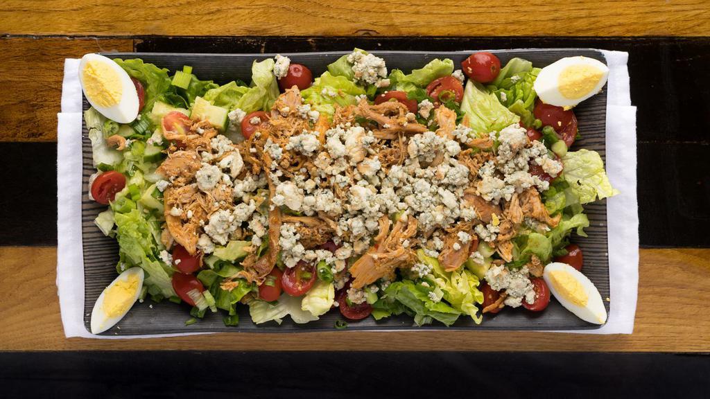 Cobb Salad · Romaine lettuce, bacon, smoked blue cheese, hard-boiled egg, cucumber, tomatoes and onions. Choice of dressing.