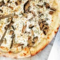 Truffle Mushroom Pizza · Cheese-based white sauce, mushrooms and truffle. Topped with parsley and oil.