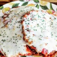 Eggplant Parmesan · Breaded eggplant, baked with our house tomato sauce and melted mozzarella cheese. Served wit...