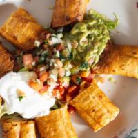 Flautas · 4 Flour tortillas rolled with shredded stew or chicken. Served with guacamole  salad, rice a...