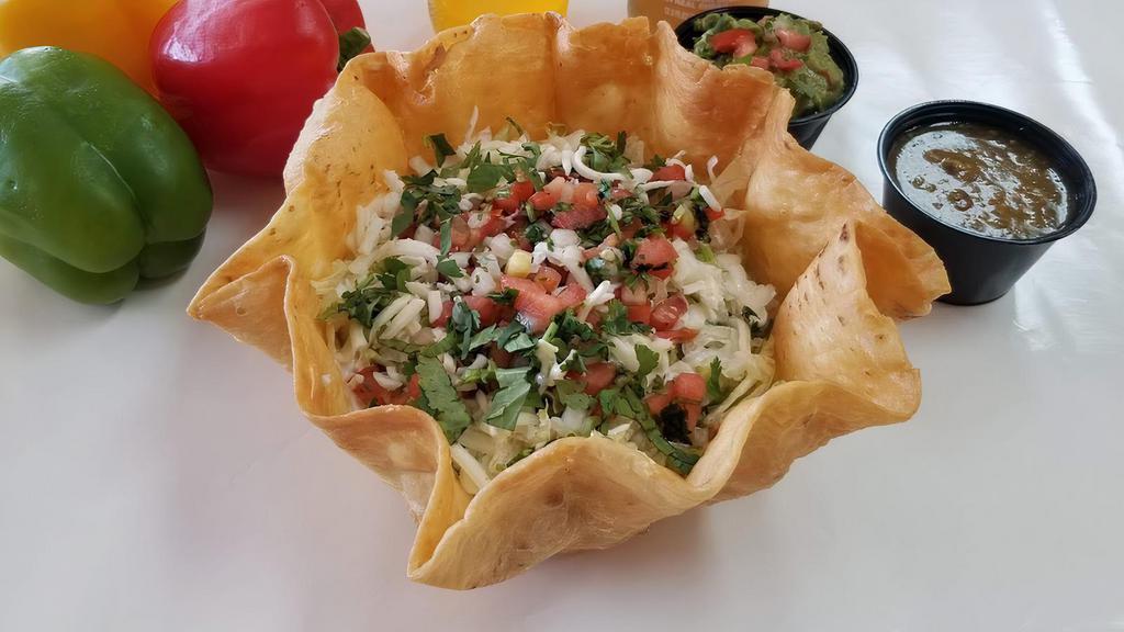 Taco Salad · Taco Salad comes on a Flour Crunchy shell with Mexican rice, beans, your choice of meat and toppings from our salad bar ! salsa, cilantro, onions, cheese, sour cream, pico de gallo, and lettuce.