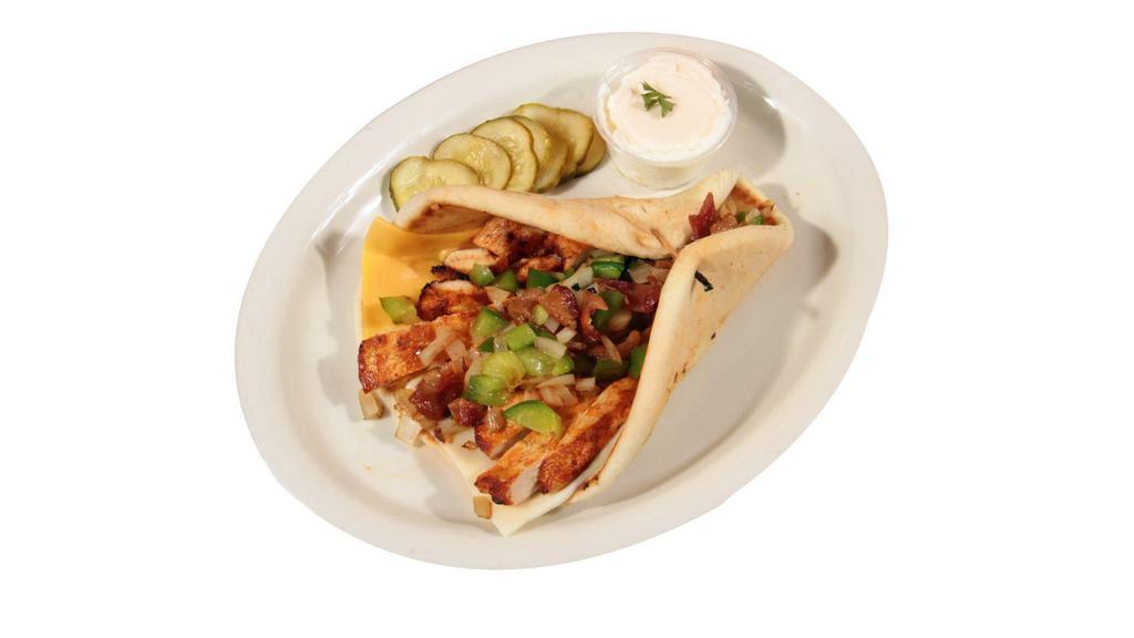Wilson'S Pita · Served with grilled chicken, Swiss, American cheese, bacon, green pepper, & onion.