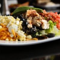 Chicken Cobb Salad · Chopped garden blend, chicken, applewood smoked bacon, tomatoes, black olives, cheddar and g...