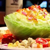 Wedge Salad · Wedge of iceberg lettuce, bacon, diced egg, red onion, crumbled gorgonzola, cherry tomatoes ...