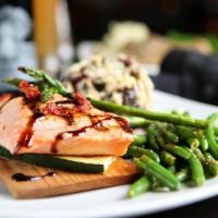 Cedar Plank Scottish Salmon · Topped with balsamic glaze, grilled zucchini, sautéed asparagus and sun-dried tomatoes.