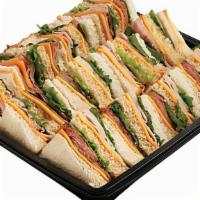 Finger Sandwich Snack Square · Delicately stacked sandwiches filled with Primo Taglio sliced turkey breast, ham, American a...
