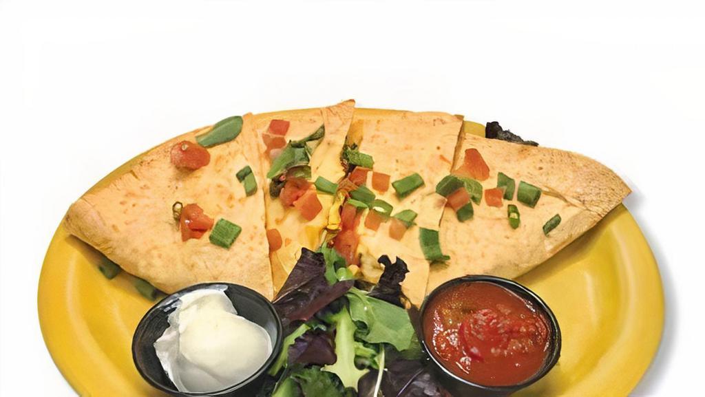 Breakfast Quesadilla · Cheddar and jack cheeses, chorizo sausage, jalapenos and onions blended into fluffy scrambled eggs and stuffed into a large tortilla shell.  Quartered and served on a plate with salsa and sour cream.
