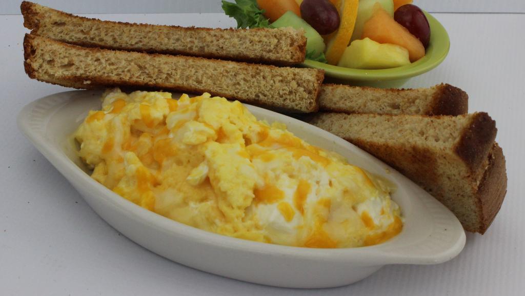 Wisconsin Scrambled · Our freshly cracked eggs scrambled with a blend of monterey jack, cheddar, and cream cheeses. Served with your choice from the bread pantry and a scrambler side. Comes with your choice of sides.