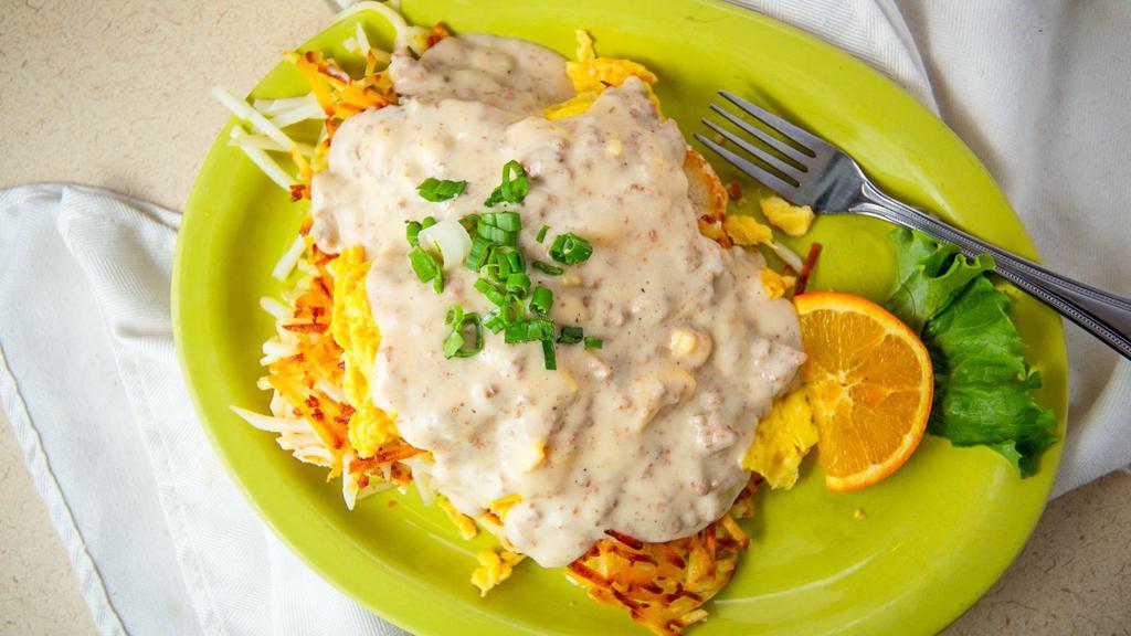 Big Country · A layering of biscuits and golden hash browns piled high with two farm-fresh eggs any style and smothered in a hearty sausage gravy and chives.