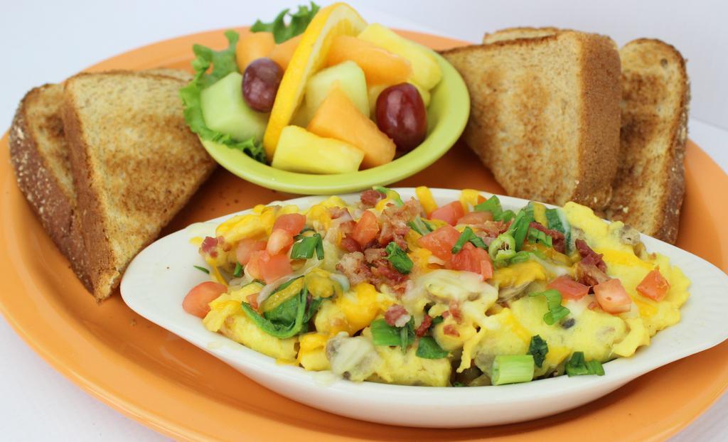 Eye Opener · Freshly cracked eggs scrambled with portabella mushrooms, chives, fresh spinach, bacon topped with diced tomatoes and a blend of monterey jack and cheddar cheeses.