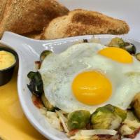 Sunrise Sprouts · A skillet of fresh Brussels sprouts sautéed with hash browns, onions, and diced bacon.  Topp...