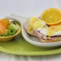Traditional Benny · Smoked ham and two poached eggs on a toasted English muffin covered in rich, creamy Hollanda...