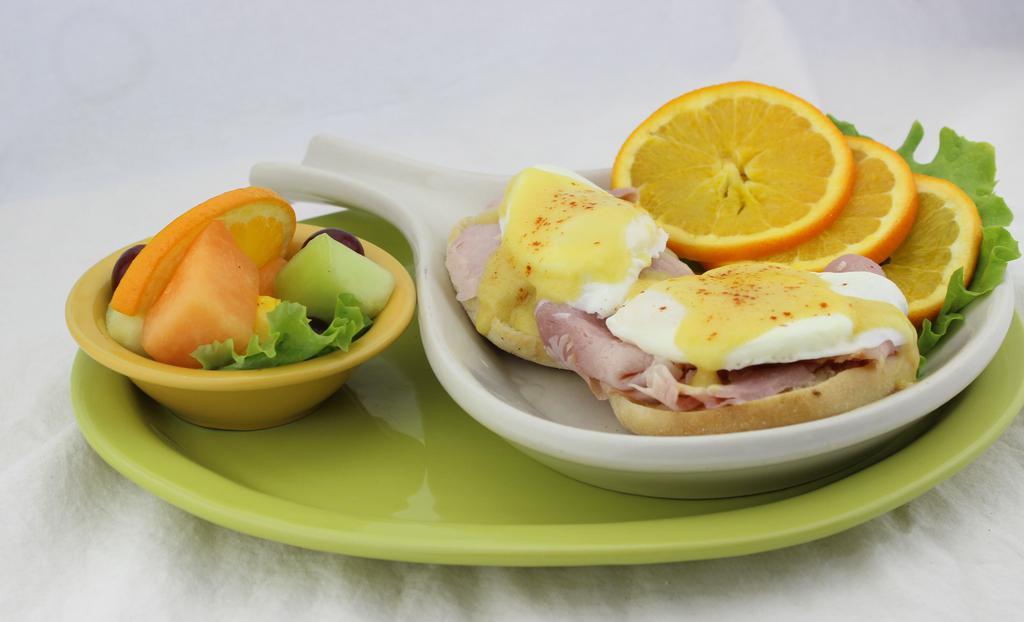 Traditional Benny · Smoked ham and two poached eggs on a toasted English muffin covered in rich, creamy Hollandaise sauce.