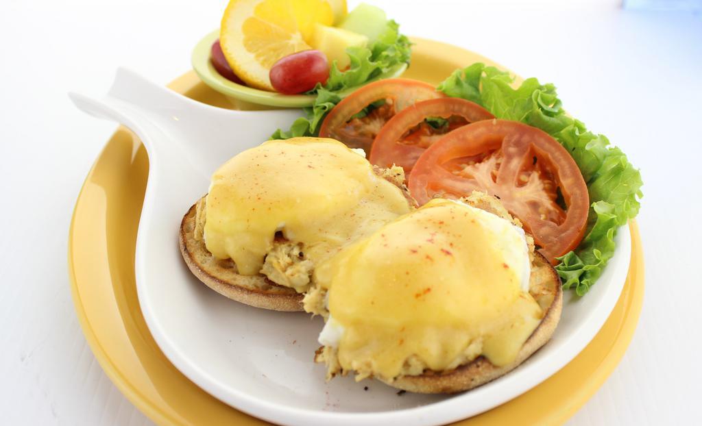 Crab Cake Benny · Two Maryland-style crab cakes made with 100% blue crab, topped with two poached eggs on a toasted English muffin and covered in rich, creamy Hollandaise.