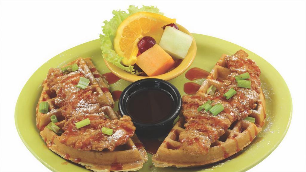 Chicken And Waffles · Breaded chicken tenders on a Belgian waffle, sprinkled with powder sugar and chives.  Served with our zesty syrup.