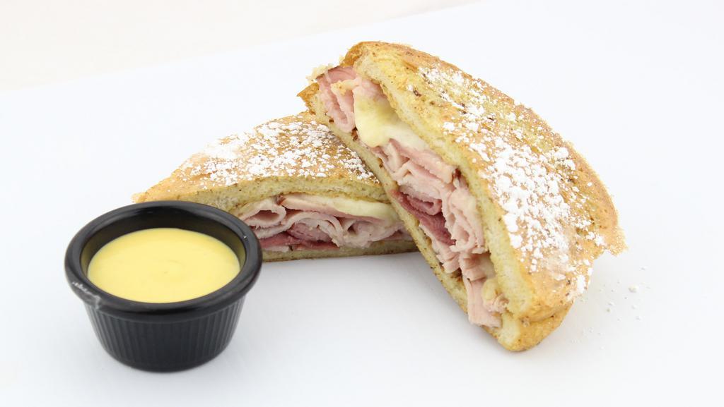 Monte Cristo · Our signature sourdough French toast filled with lean ham and turkey topped with fresh swiss cheese and sprinkled with powdered sugar. Served with classic honey mustard to add just the right amount of sweet zip.