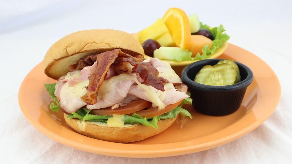 Chicken Club · Grilled chicken, bacon, lettuce, and tomato with chipotle sauce on a brioche roll.