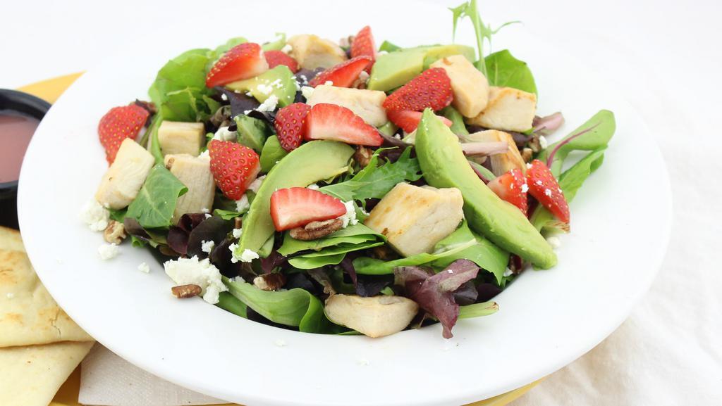 Sunshine Salad · A bed of fresh mixed greens topped with grilled chicken, avocado, pecans, strawberries, and feta cheese. Served with raspberry vinaigrette dressing.