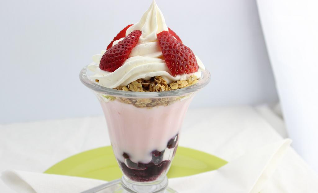 Yogurt Parfait · Strawberry low-fat yogurt layered with granola, blueberries, and strawberries. Topped with whipped cream.
