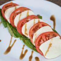Caprese Salad · Serving; 2 a bed of fresh spinach topped with layers of sliced tomoates, fresh mozzarella an...
