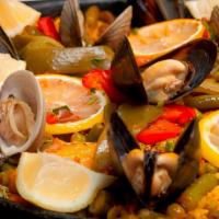 Paella Alicantina · Catch of the day, shrimp, calamari, scallops, clams, mussels and vegetables. Paellas are fre...