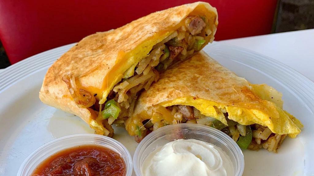 Breakfast Burrito · Scrambled eggs mixed with hash brown, bacon or sausage or chorizo or gyro or house pastrami, cheese, onion, pepper.