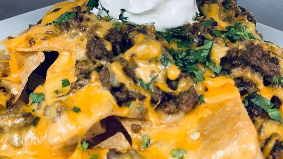 Beef Nachos · Tortilla chips piled with melted cheese, beef, jalapeños and sour cream.