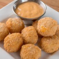 Three Cheese Bites · Olga's special three cheese blend, lightly breaded, served with our signature sauce.