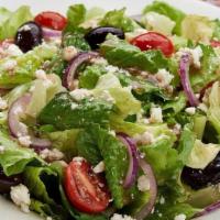 The Olga Salad® · Romaine and iceberg lettuce, red onions, Kalamata olive, vine-ripened tomato, feta, Olga’s h...