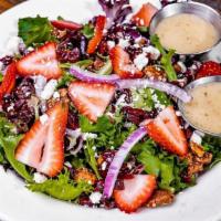 Strawberry Field Salad · Field greens, fresh strawberries, red onion, feta, cranberries, candied pecans, white balsam...
