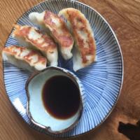 Gyoza · Combination pork, chicken and vegetable potstickers served with dipping sauce (five pieces).