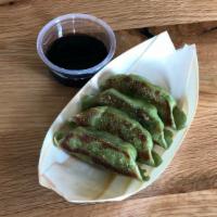 Veggie Gyoza · Vegetable filled potstickers served with dipping sauce (five pieces). Vegan.