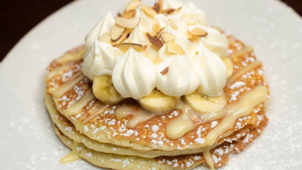 Banana Cream Pancakes · fresh bananas in 3 made-from-scratch buttermilk pancakes topped with bananas, vanilla cream drizzle, whipped cream and toasted almonds.