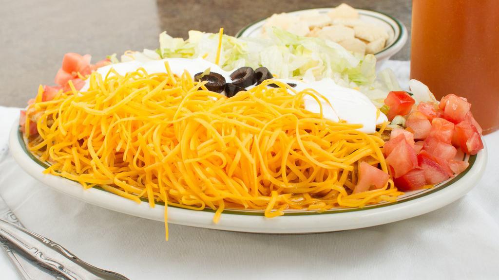 Chili Deluxe Burrito · Skyline chili in a tortilla, topped with more chili, tomatoes, lettuce, shredded cheddar cheese and sour cream.