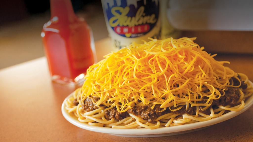 Vegetarian Ways: 3-Way Black Beans & Rice · Teaming spaghetti covered with Skyline's Vegetarian Black Beans and Rice and topped with a mound of shredded cheddar cheese.