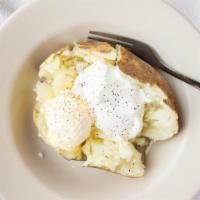 Sour Cream Potato · Topped with margarine and sour cream.